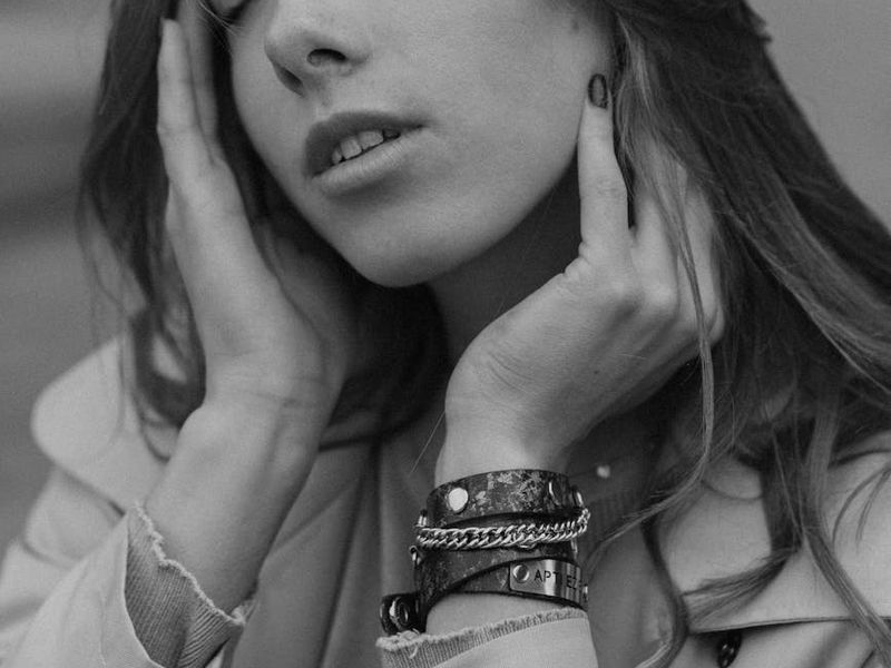 A person sitting calmly in a meditative posture in a minimalist room.